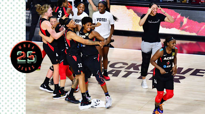 The Las Vegas Aces hug and celebrate on the court.